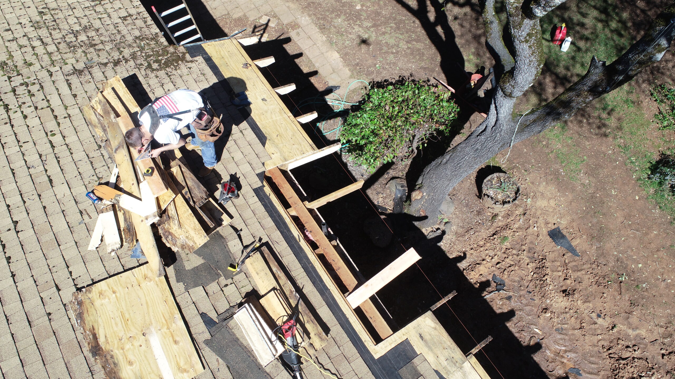 Kolby from Richard Hockett Roofing, deeply engaged in intricate woodwork, demonstrating our team's skill in detailed roofing construction.