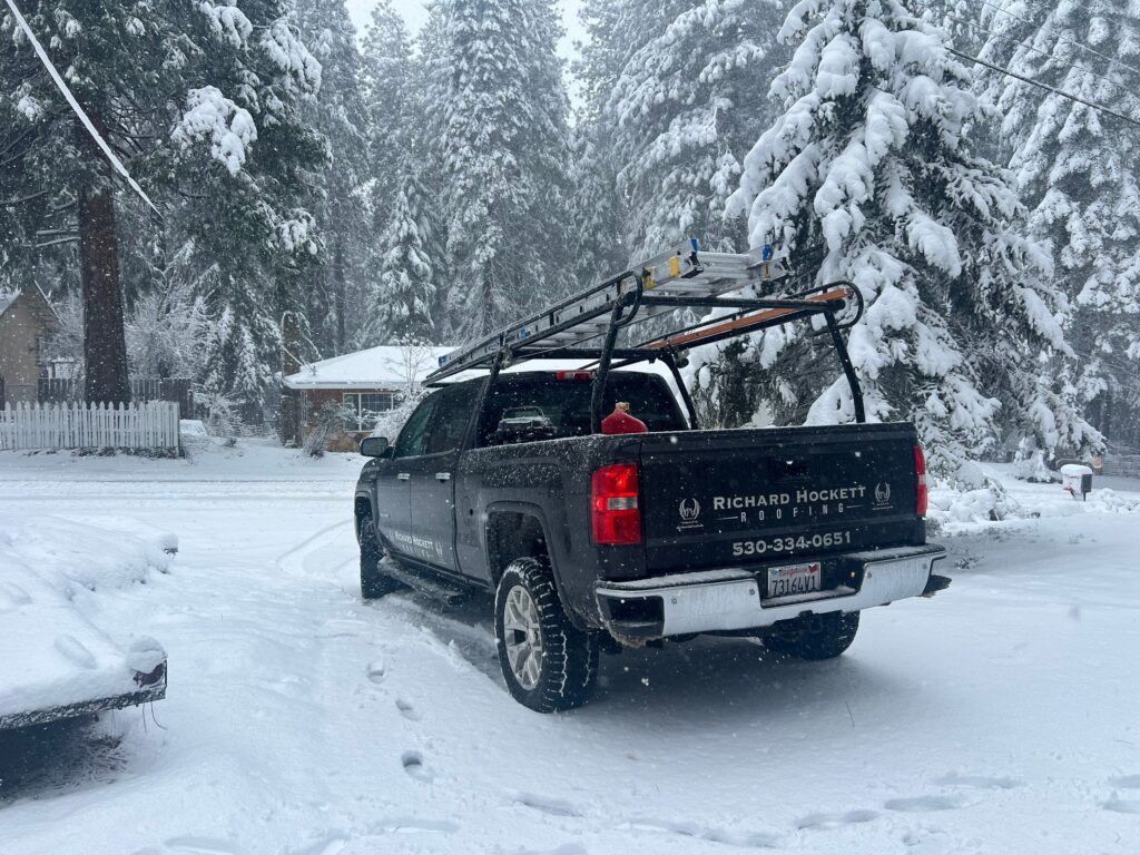 Richard Hockett Roofing truck in snow responding to pollock pines roof damage during winter storm